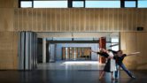 Two people performing at the Moonah Art Centre containing Capral window and building systems.