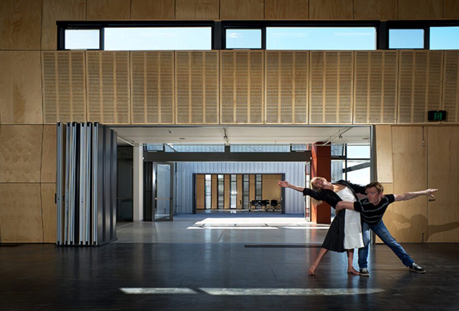 Two people performing at the Moonah Art Centre containing Capral window and building systems.
