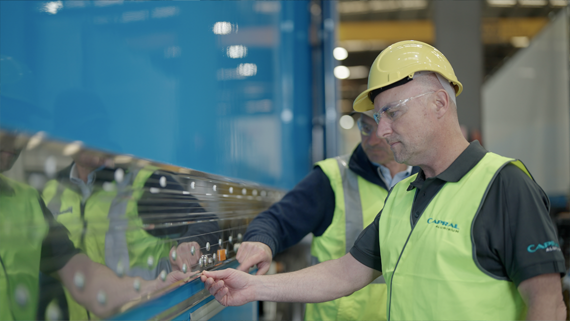 photo of capral and vawdrey employee looking at aluminium on a truck