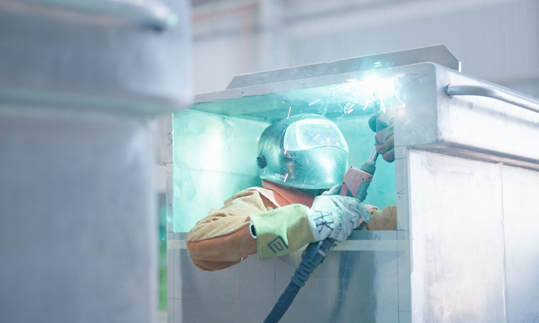 A picture of a man welding Capral's aluminium to create the boat
