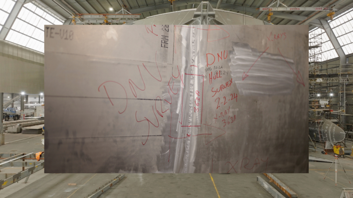 A picture of scribbled writing including "DNV" on the ship
