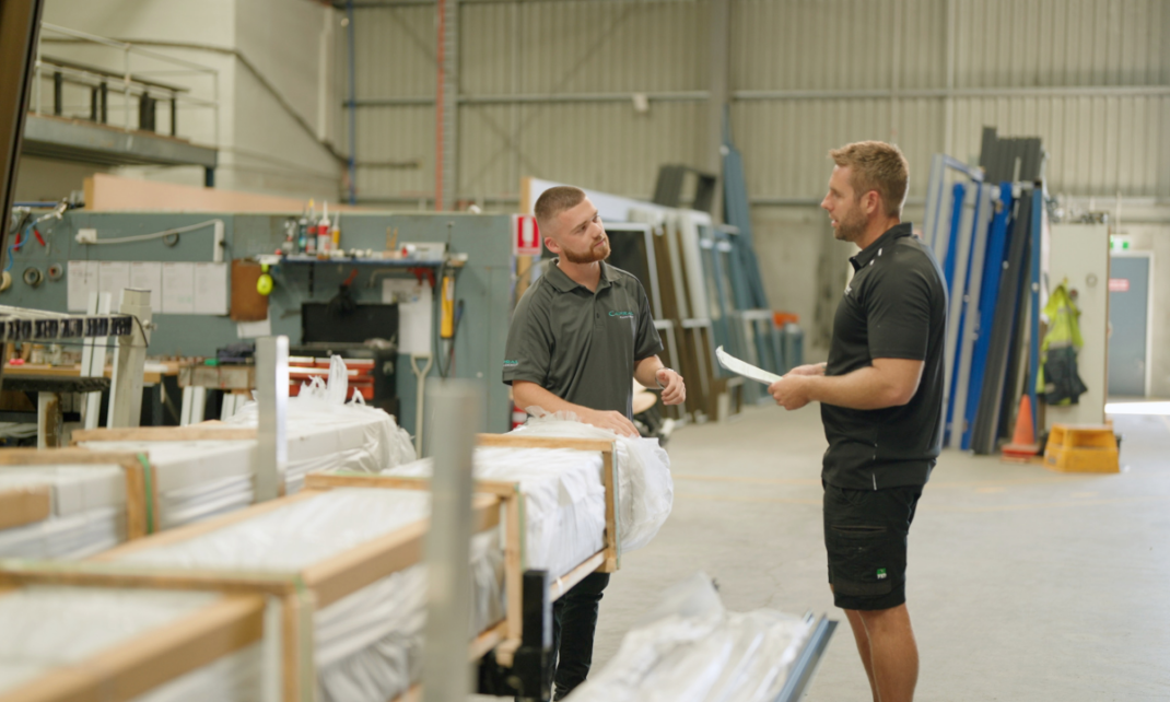 A picture of PCW and a Capral employee discussing and building a relationship