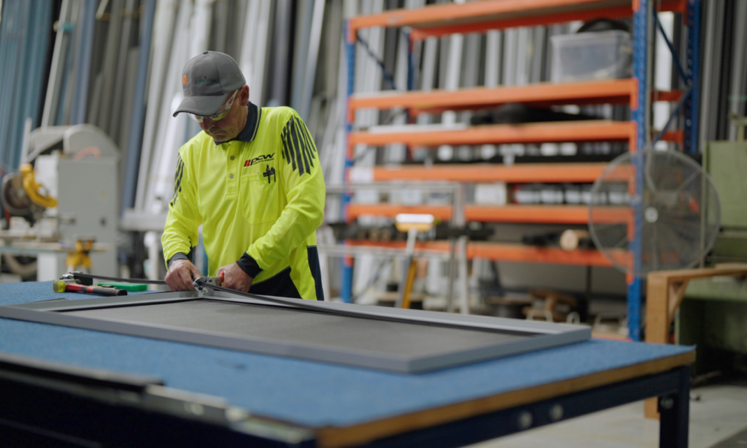 A picture of a PCW fabricator working on building Amplimesh Supascreen