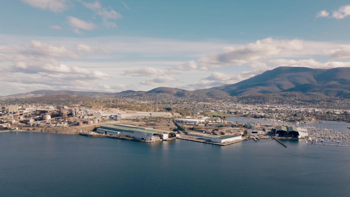 A picture of Incat's company with the beautiful tassie landscape behind it