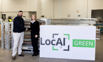 A capral representative and airfoil representative shaking hands signifying Airfoil's business shift to use local green.