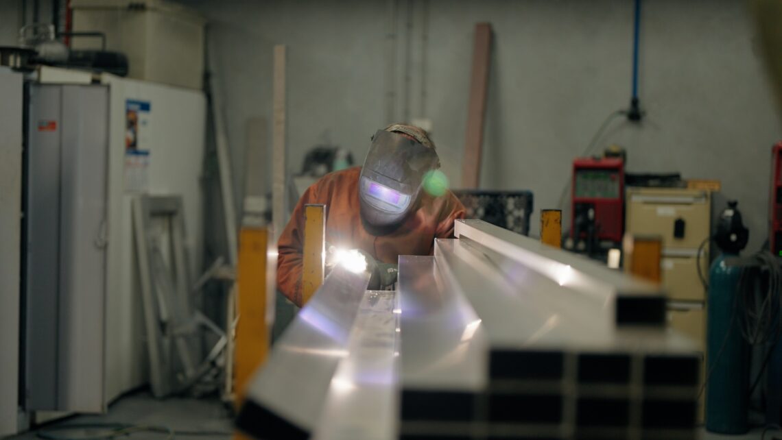 A photo of one of BAB employees cutting aluminium