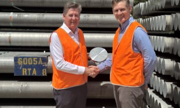 A photo of Capral's CEO and Rio Tinto's CEO shaking hands