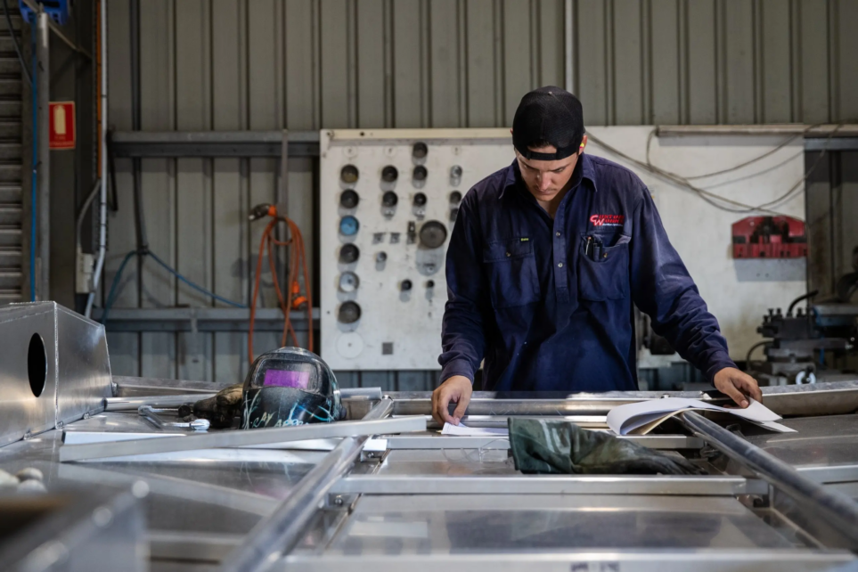 A photo of one of Custom works employees working on their aluminium boats