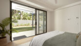 A bedroom at the residential home the palms collaroy featuring a capral door
