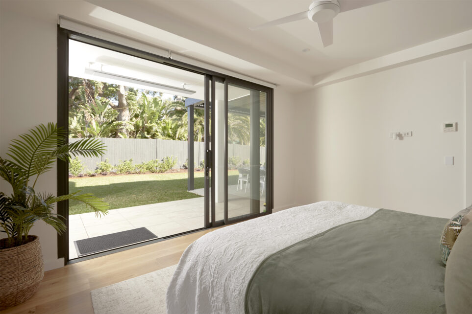 A bedroom at the residential home the palms collaroy featuring a capral door