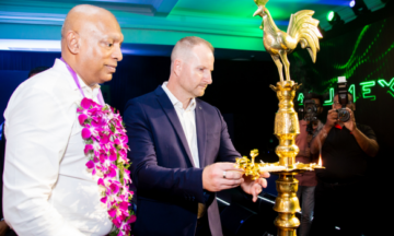 A photo of a Capral employee and Alumex employee coming together highlighting their new partnership