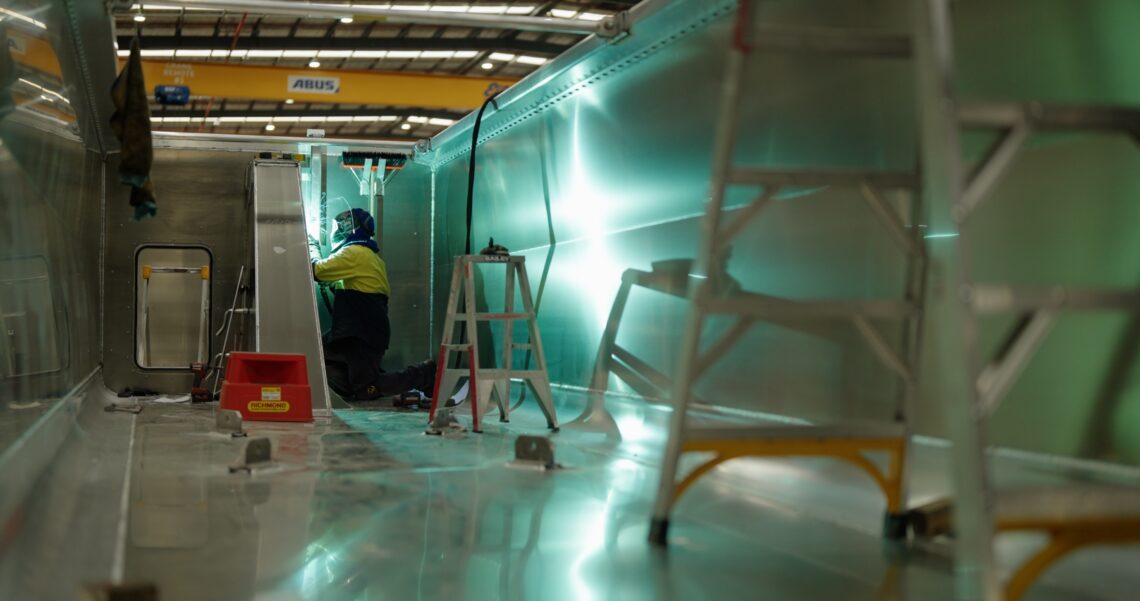 A picture of a worker using capral aluminium to help build sloanebuilt's trailer
