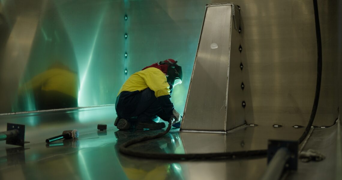 A close up of a sloanebuilt worker building a trailer