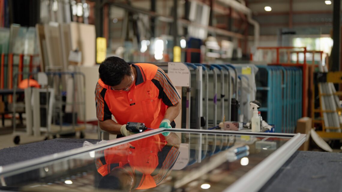 A photo of one of wellhung's employees working to create a high quality door.